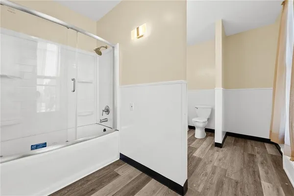 a view of a bathroom with wooden floor
