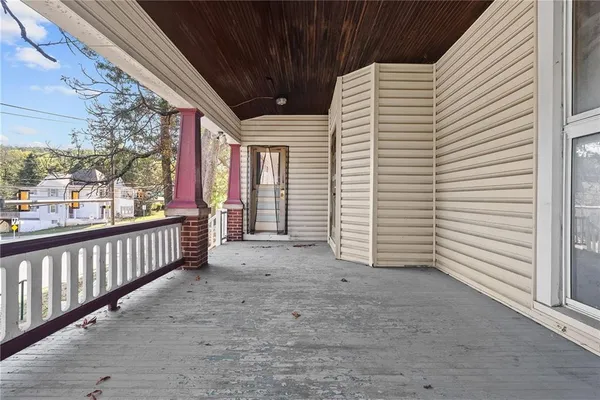 a view of a porch with wooden floor