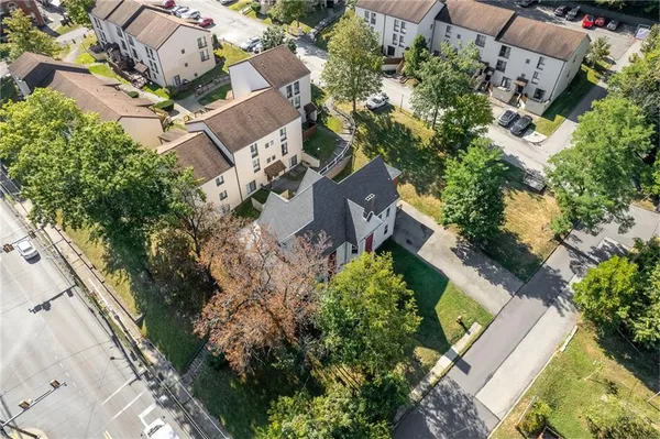an aerial view of a house with a yard