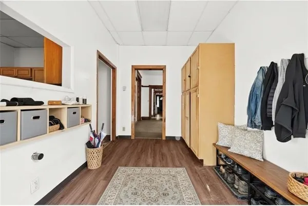 a view of a hallway with wooden floor and staircase