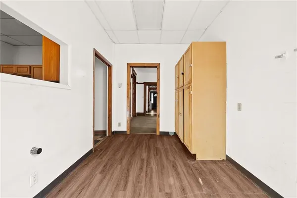 a kitchen with cabinets and wooden floor