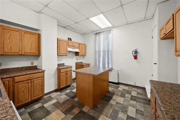 a kitchen with granite countertop a sink and cabinets