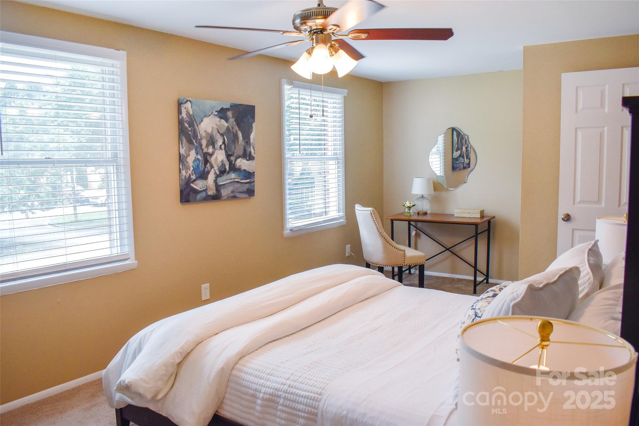 7526 Holly Grove Court Charlotte, NC 28227 - Photo 15 of 42 a bedroom with a bed and a chandelier