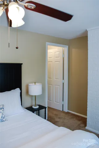 a bedroom with a bed and a lamp on table