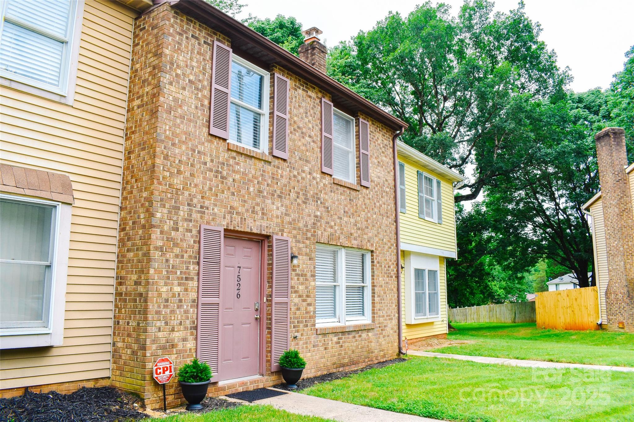 7526 Holly Grove Court Charlotte, NC 28227 - Photo 2 of 42 a front view of a house with garden