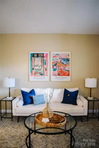 a living room with furniture and a lamp