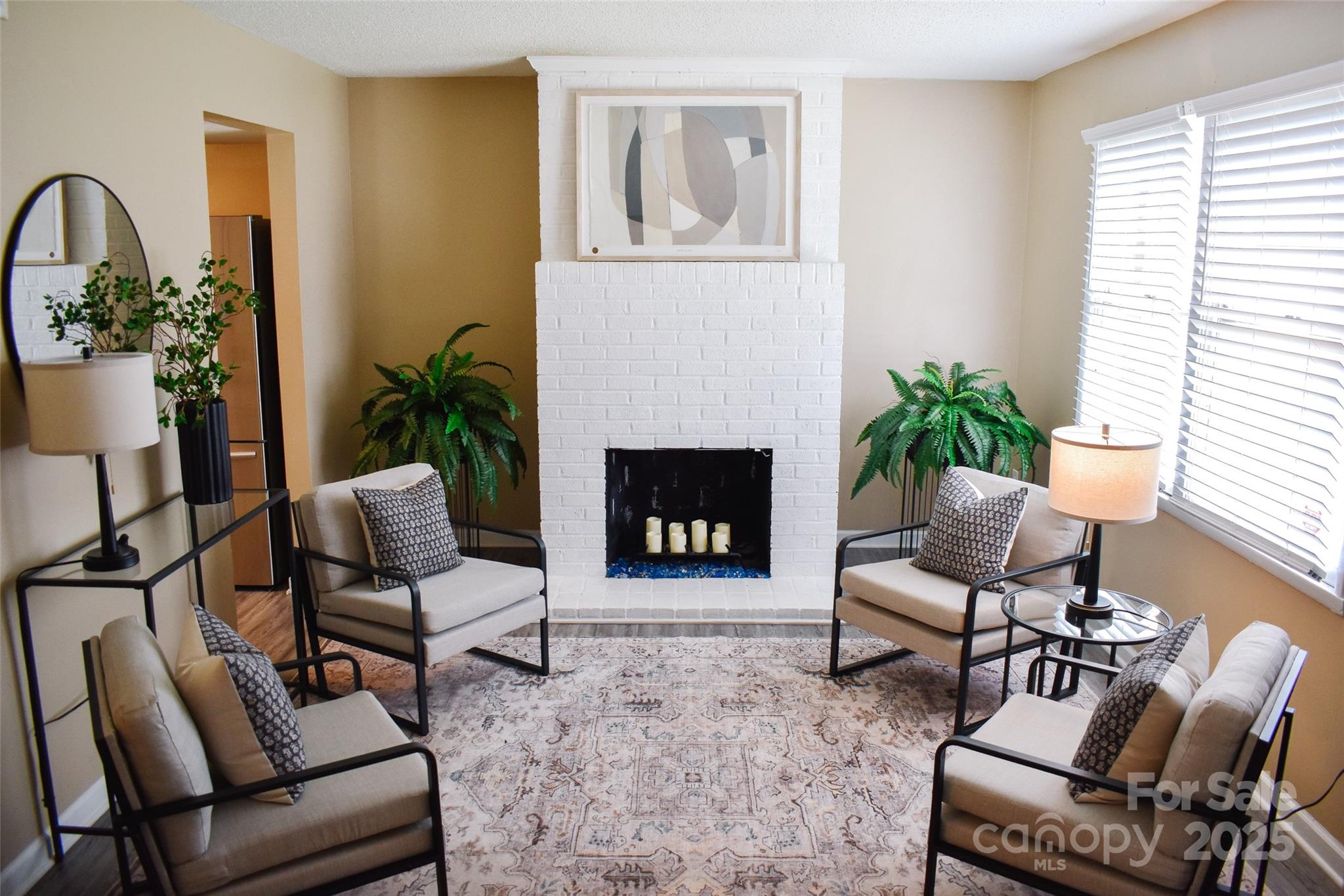 7526 Holly Grove Court Charlotte, NC 28227 - Photo 3 of 42 a living room with furniture a potted plant and a fireplace