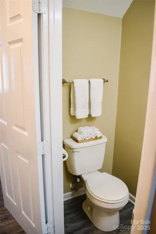 a white toilet sitting next to a small bathroom