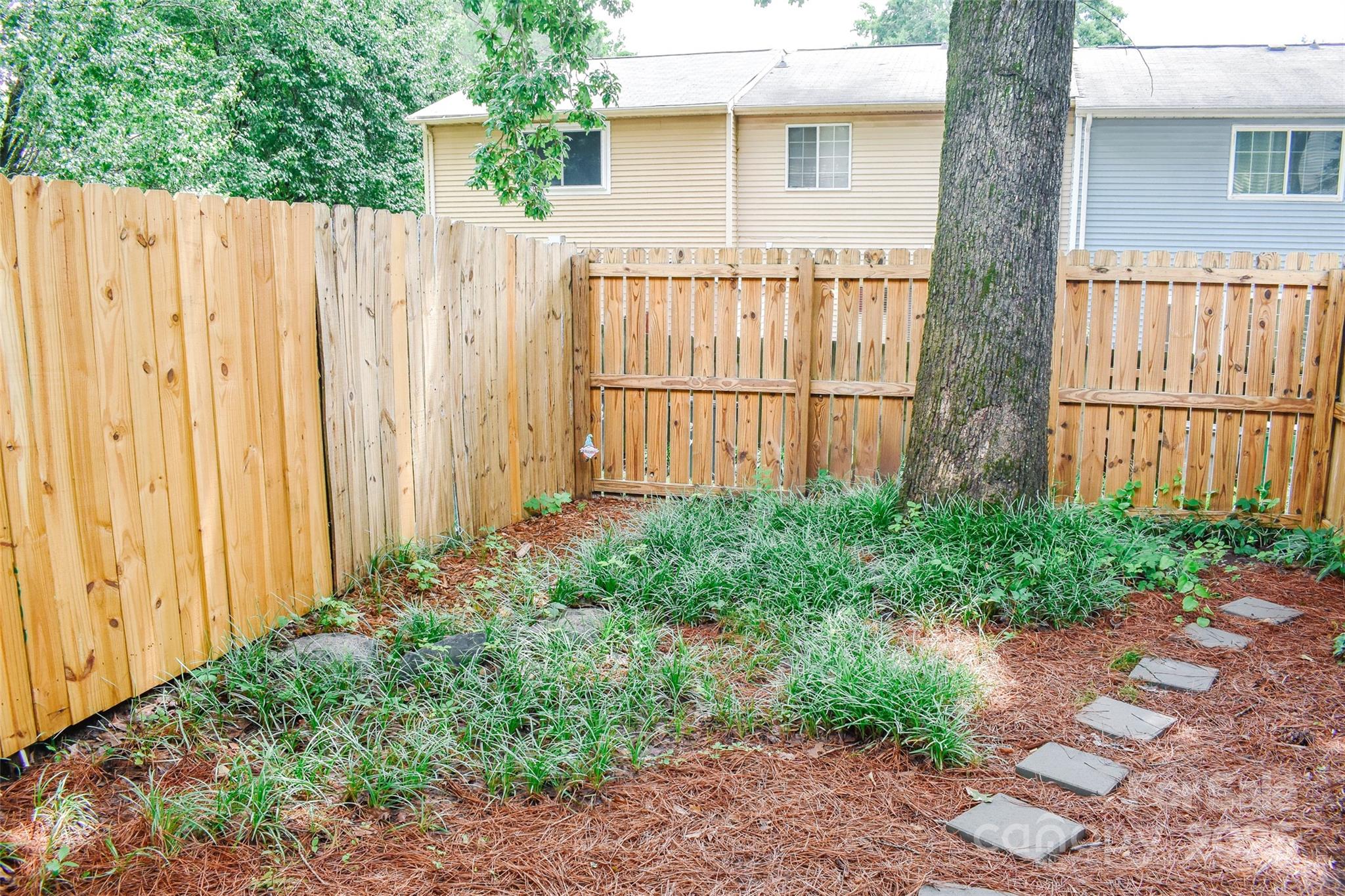 7526 Holly Grove Court Charlotte, NC 28227 - Photo 38 of 42 a front view of a house with a garden