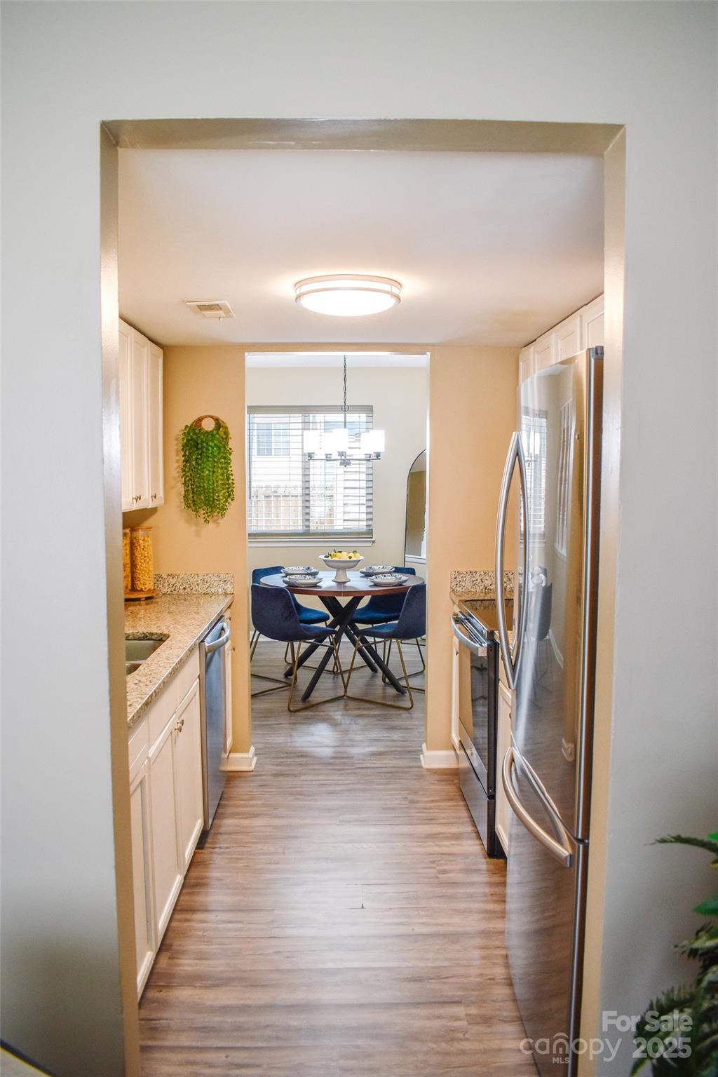 7526 Holly Grove Court Charlotte, NC 28227 - Photo 9 of 42 a living room with stainless steel appliances furniture a rug and a large window