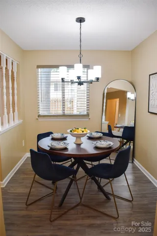 a view of a dining room with furniture and chandelier
