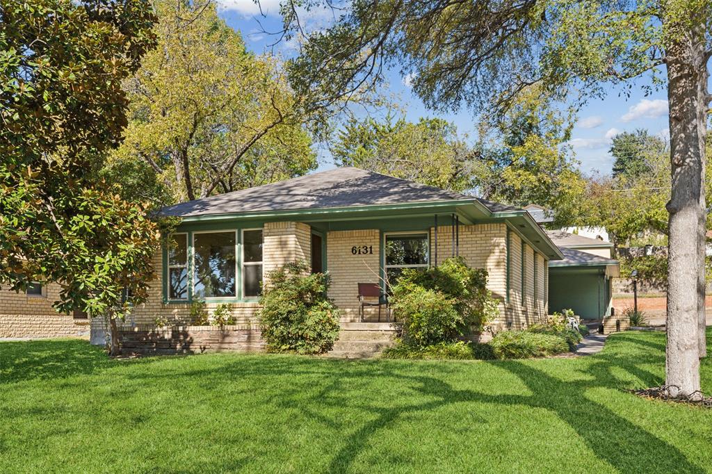6131 Scyene Road Dallas, TX 75227 - Photo 1 of 1 a front view of a house with a garden