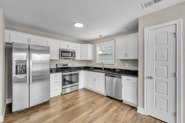 a bathroom with a shower sink and mirror