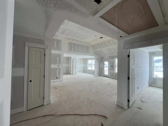 a view of a room with large windows and cabinet