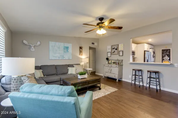 a living room with furniture and wooden floor