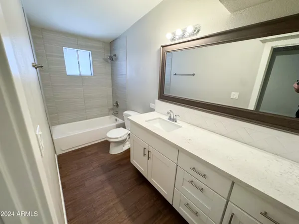 a bathroom with a double vanity sink toilet and shower