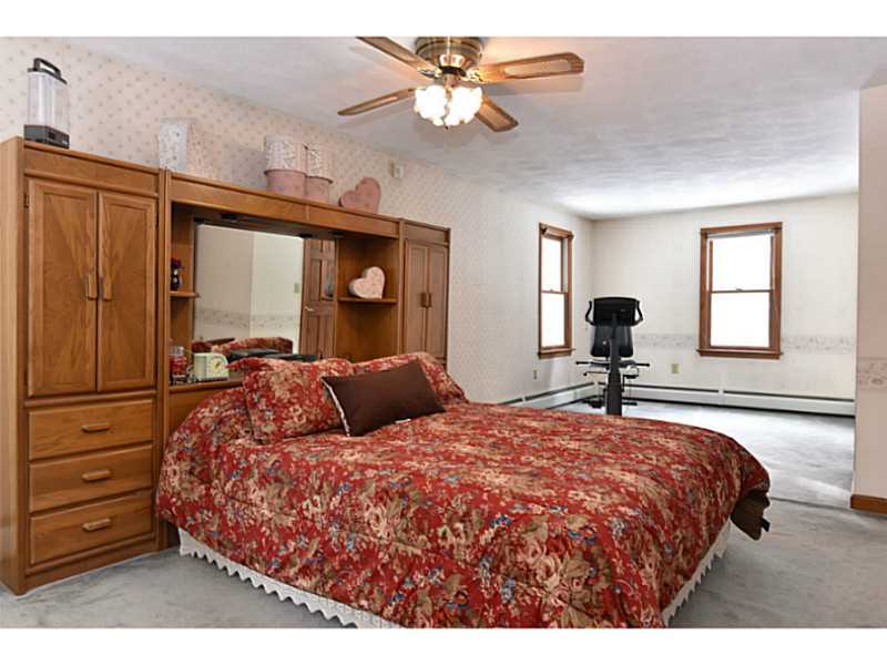 383 Trimtown Road Scituate, RI 02857 - Photo 21 of 24 Master Bedroom. Large L-shaped master bedroom with walk-in closet and ensuite bathroom with shower.