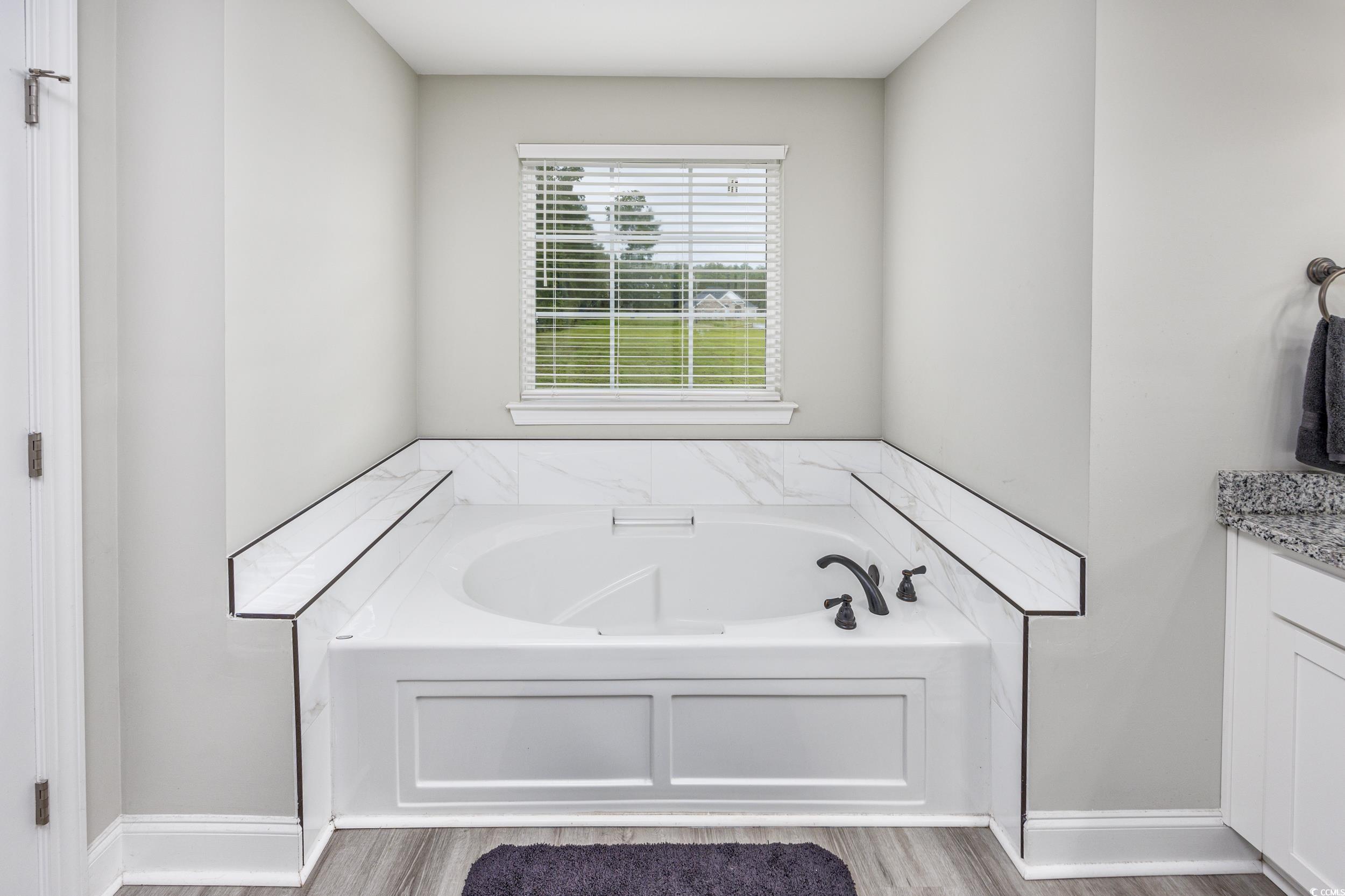 2900 Cherry Hill Road Loris, SC 29569 - Photo 17 of 34 Full bath with a garden tub, baseboards, wood fini