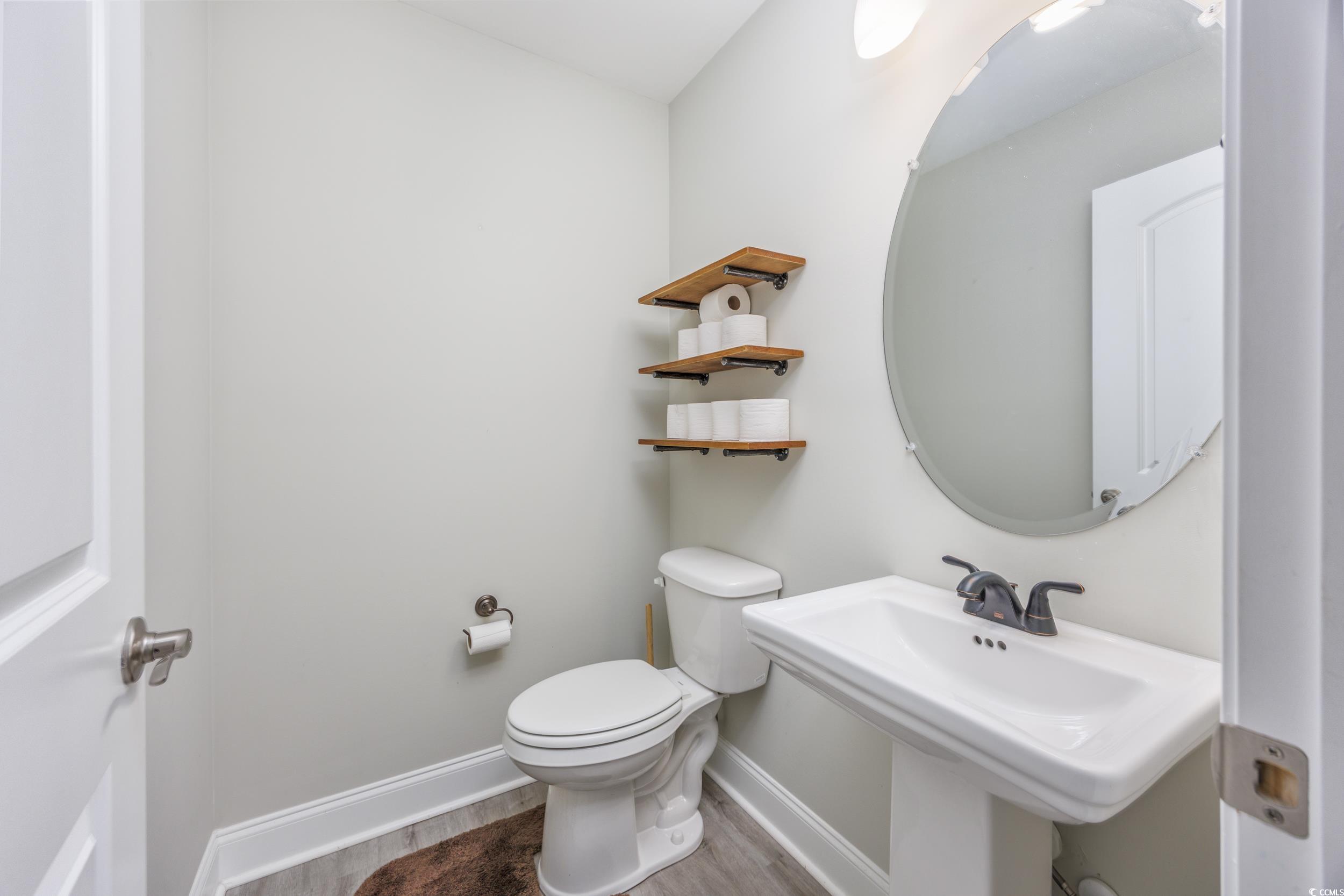 2900 Cherry Hill Road Loris, SC 29569 - Photo 24 of 34 Bathroom with toilet, a sink, baseboards, and wood