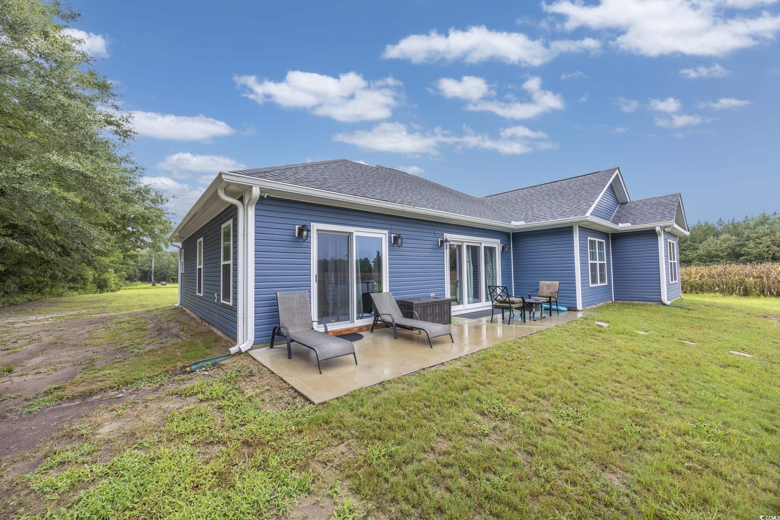 2900 Cherry Hill Road Loris, SC 29569 - Photo 27 of 34 Rear view of house with a shingled roof, a lawn, a