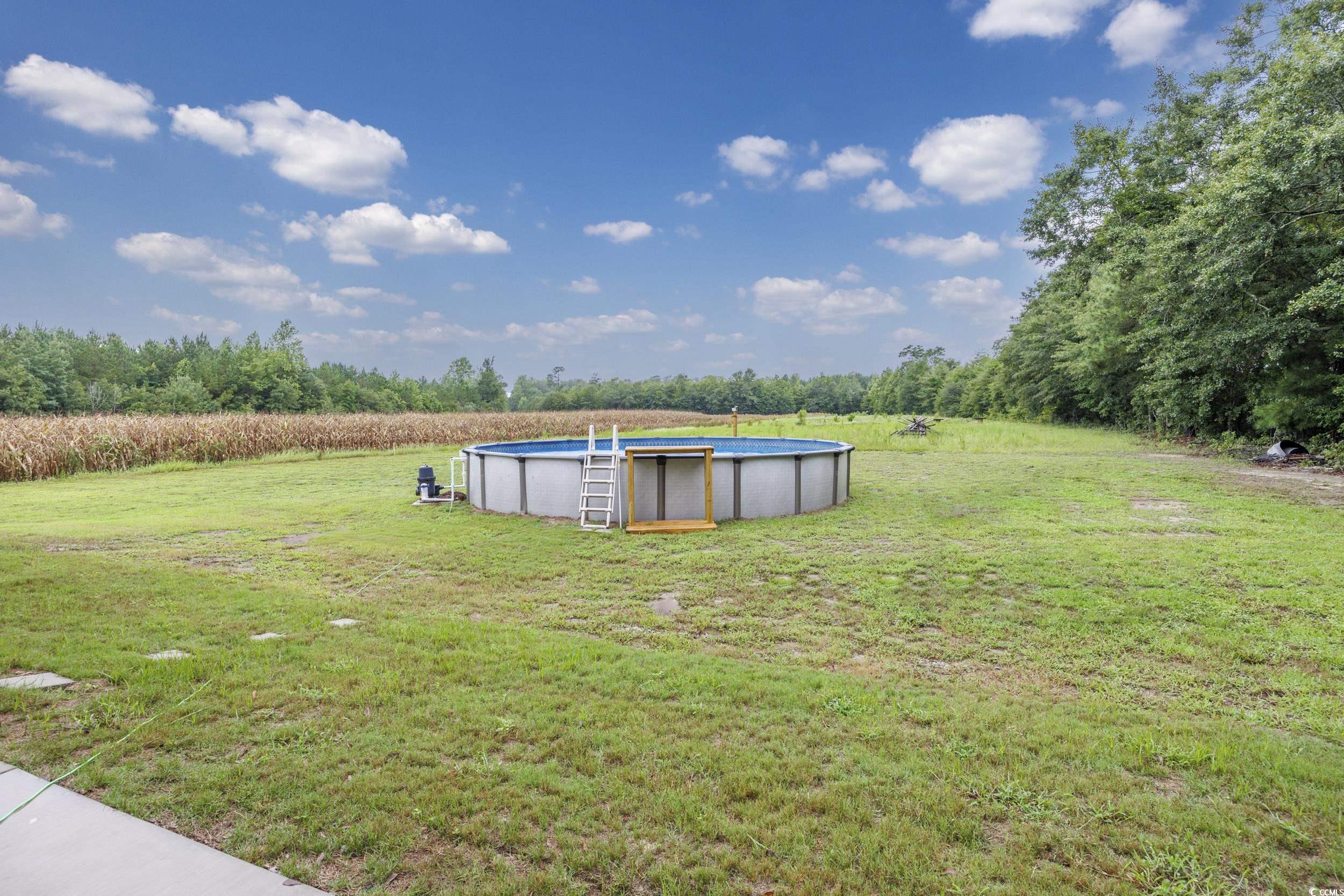 2900 Cherry Hill Road Loris, SC 29569 - Photo 28 of 34 View of yard with a rural view and an outdoor pool