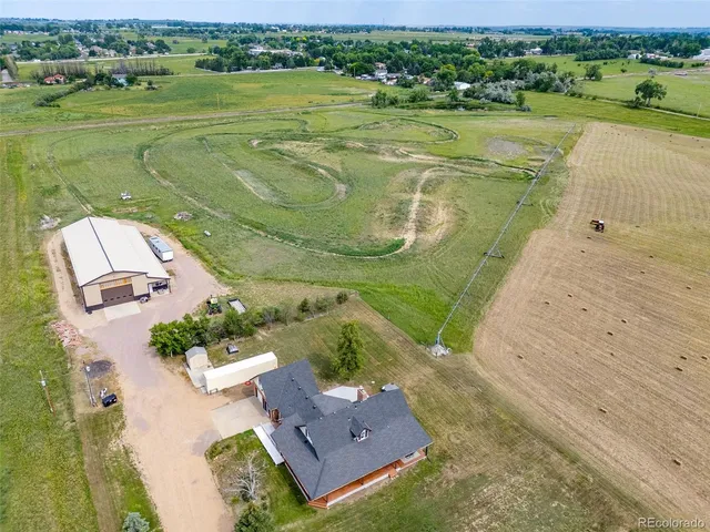 an aerial view of a house with a yard lake view and mountain view