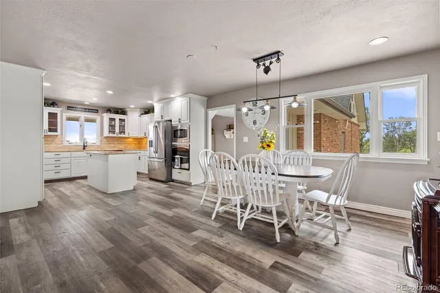a kitchen with stainless steel appliances granite countertop a sink refrigerator and cabinets