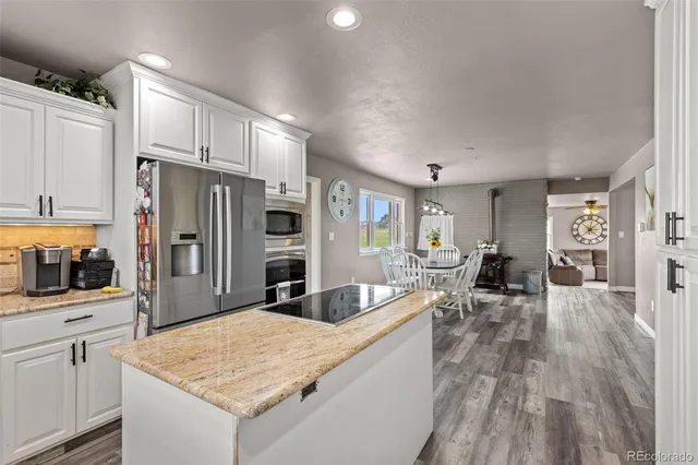 a bedroom with a bed and a large window with the outer view