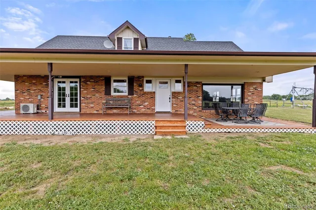 a view of a patio with dining table and chairs with wooden floor