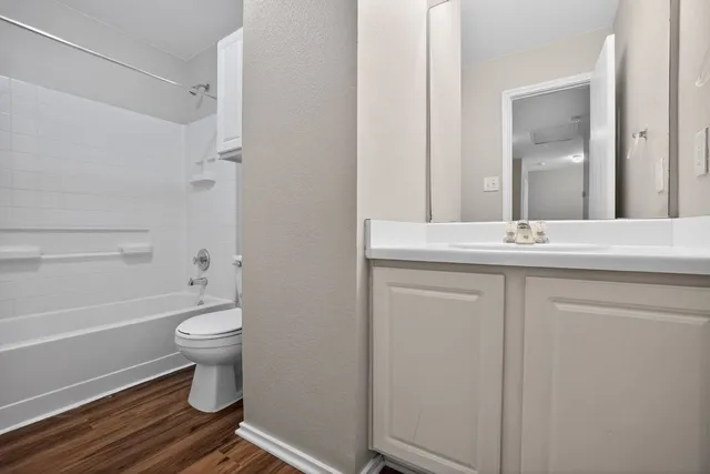 a bathroom with a tub sink and mirror