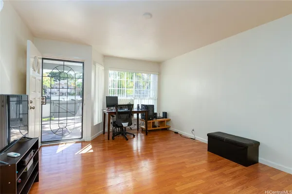 a room with furniture wooden floor and a window
