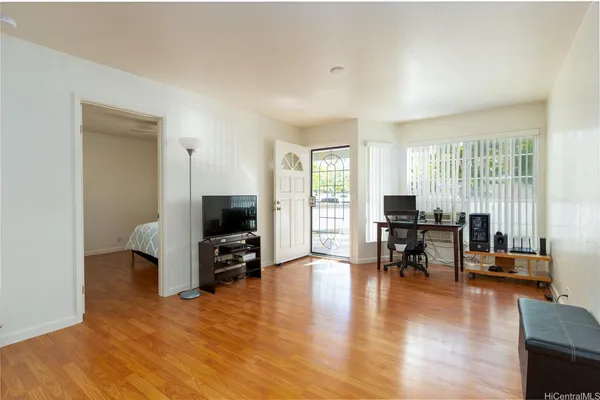 a living room with furniture and a flat screen tv