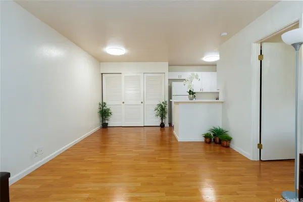 a view of a kitchen with wooden floor and a large window