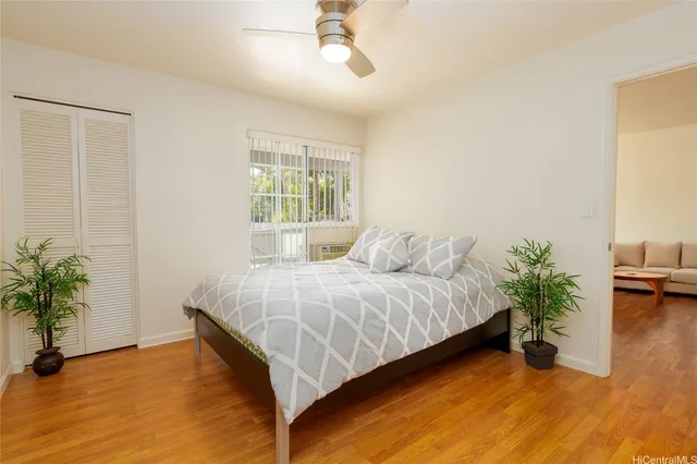 a bed sitting in a spacious bedroom next to a window