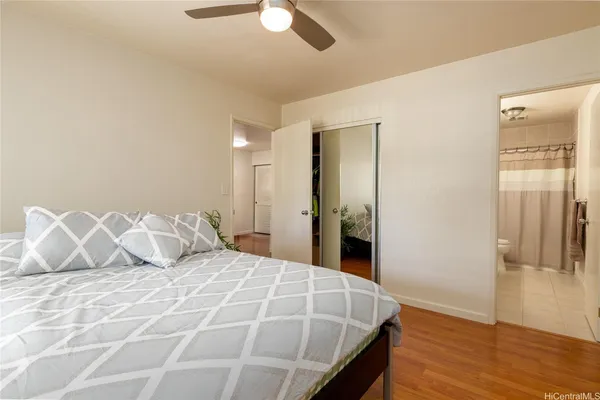 a bedroom with a bed and wooden floor