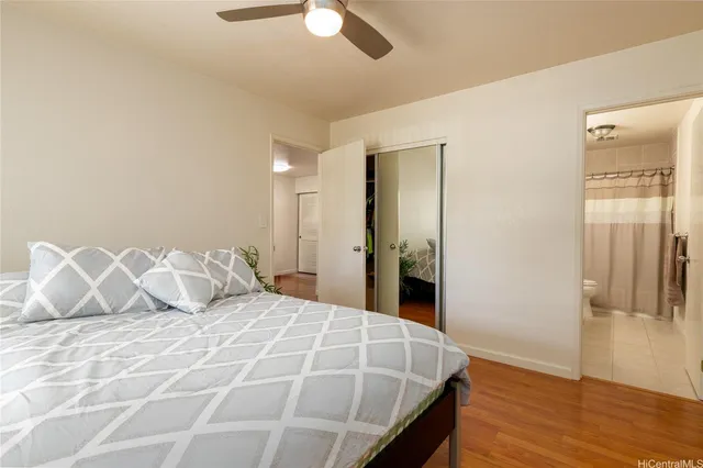 a bedroom with a bed and wooden floor