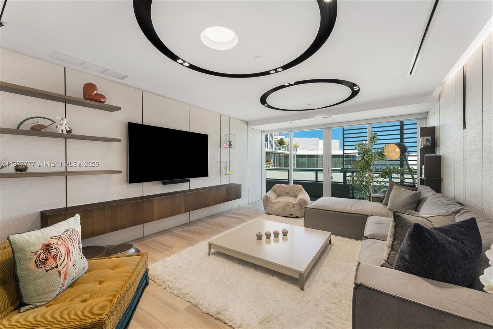 4701 Meridian Avenue, Unit 512 Miami Beach, FL 33140 - Photo 19 of 60 a living room with furniture and a flat screen tv