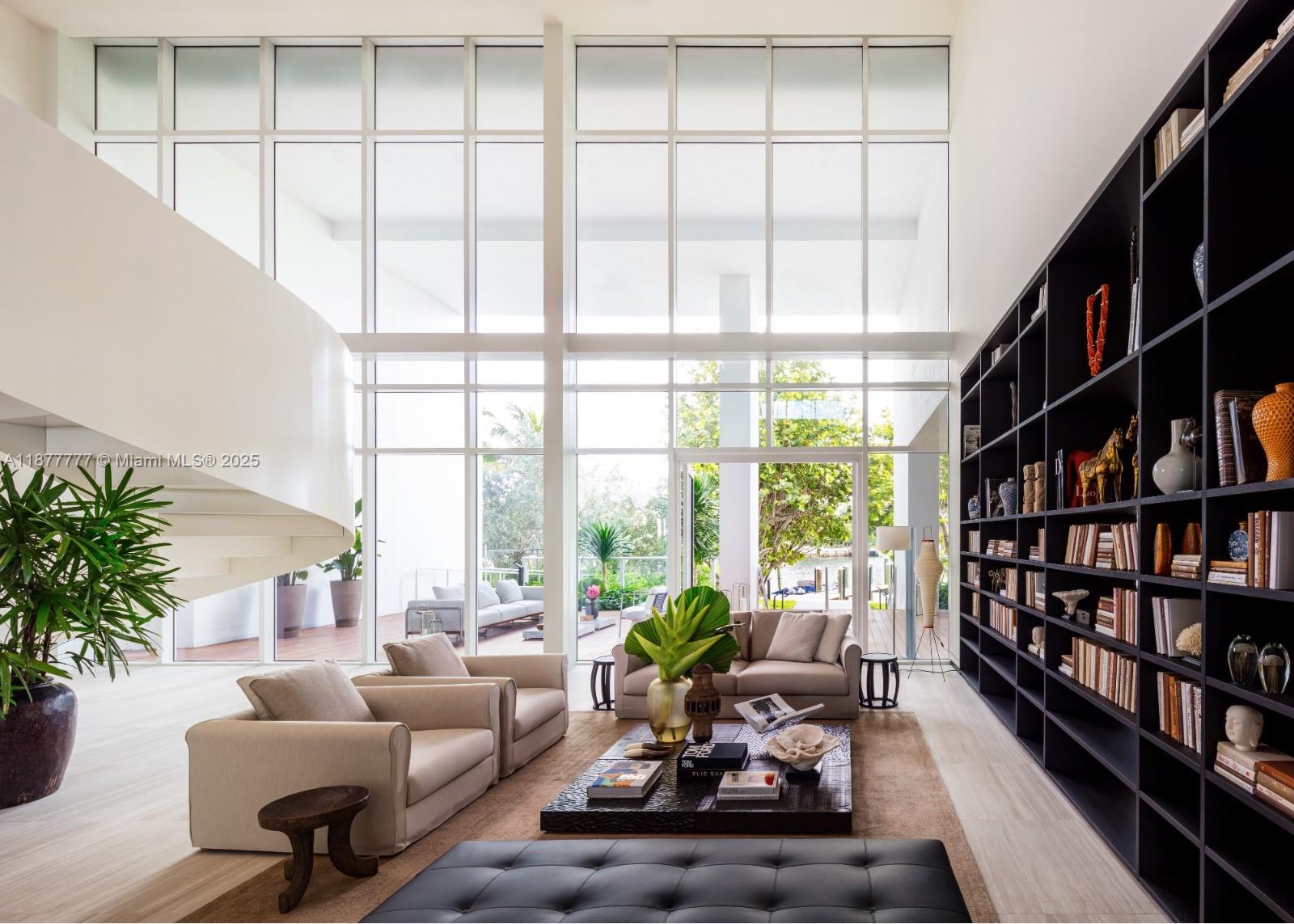 4701 Meridian Avenue, Unit 512 Miami Beach, FL 33140 - Photo 40 of 60 a living room with furniture large bookshelf and a large window