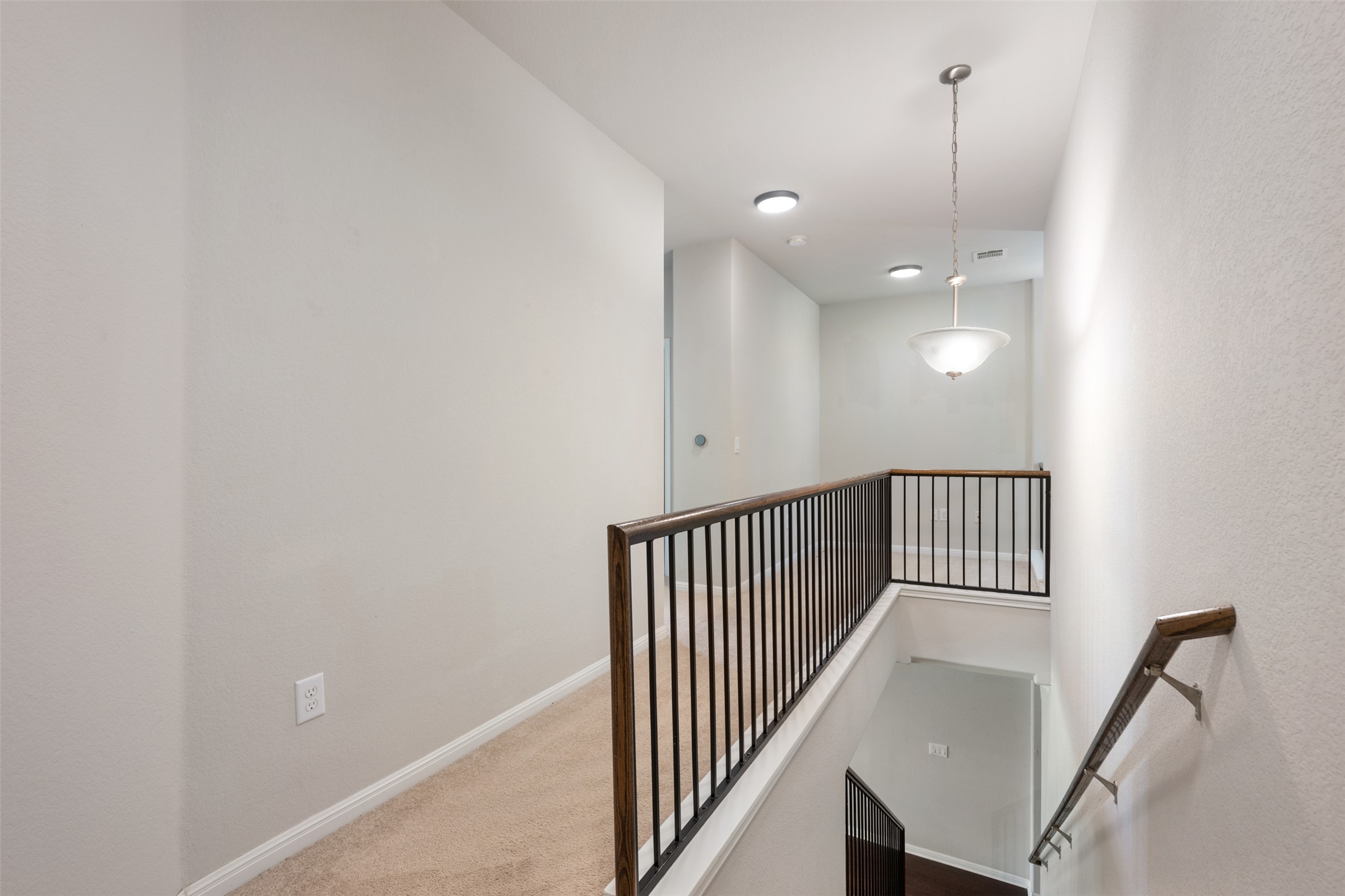 211 Parable Cove Pflugerville, TX 78660 - Photo 21 of 40 Carpeted hallway featuring light-toned walls, recessed lighting, and a contemporary chandelier