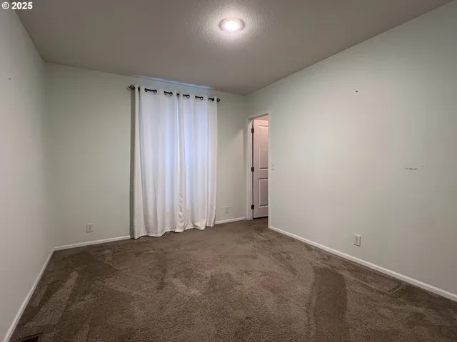 a kitchen with stainless steel appliances kitchen island granite countertop a refrigerator and a sink