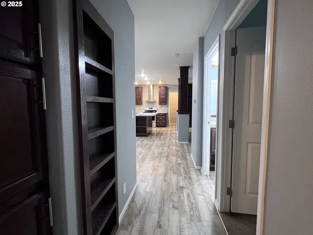 a view of a refrigerator in kitchen and wooden floor