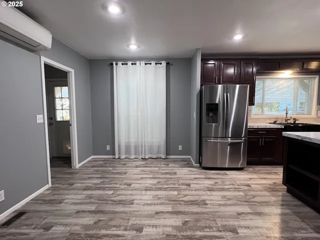 a view of a house with backyard and wooden fence
