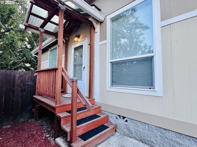 a view of a kitchen with a sink and a refrigerator
