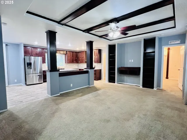 a kitchen with stainless steel appliances kitchen island sink refrigerator and stove