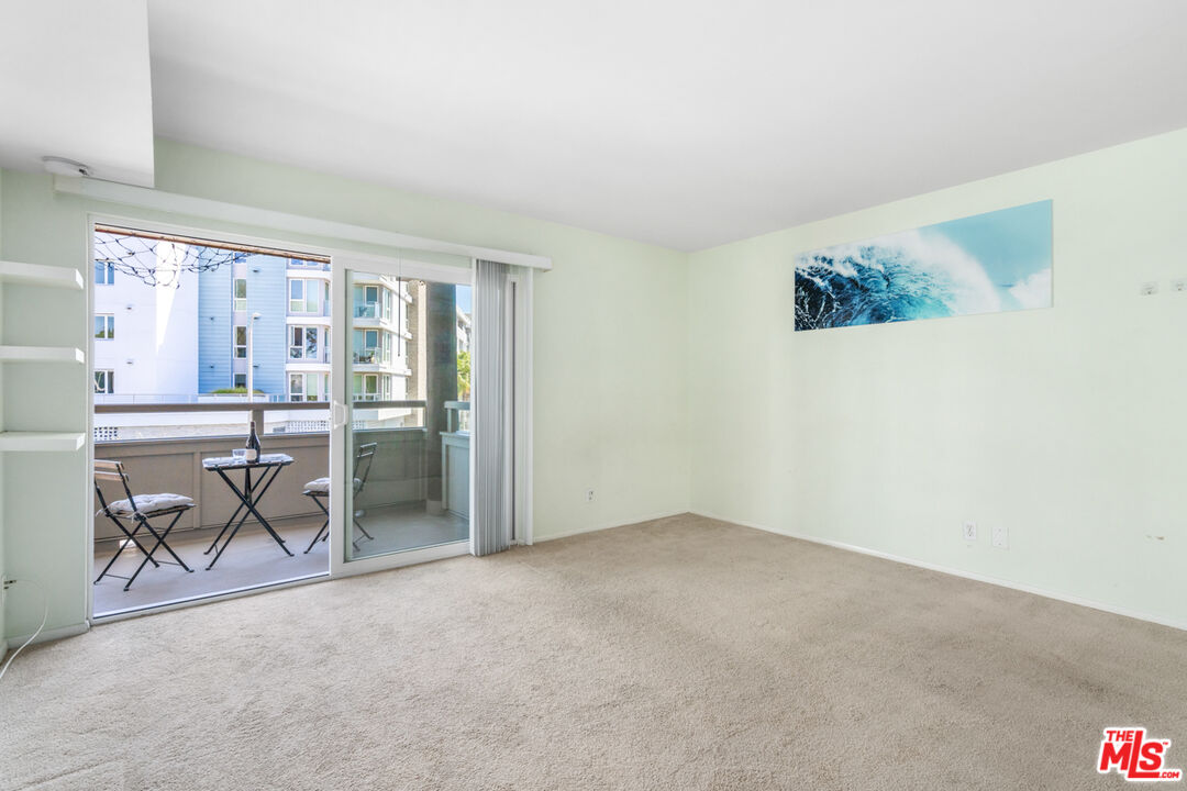 4150 Vía Dolce, Unit 236 Venice, CA 90292 - Photo 18 of 26 an empty room with furniture and windows