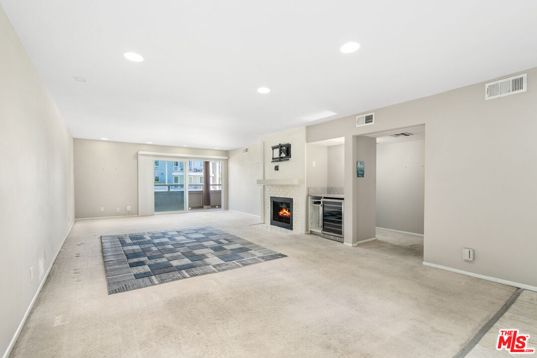 4150 Vía Dolce, Unit 236 Venice, CA 90292 - Photo 4 of 26 a view of a livingroom with a fireplace and window