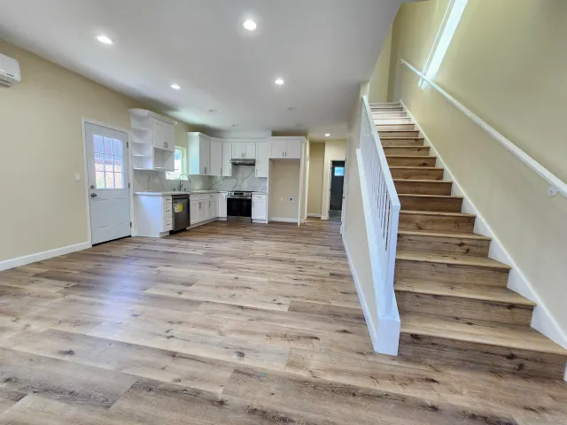 a view of kitchen and hall with wooden floor