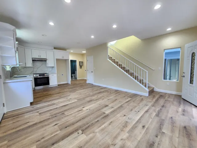a view of a kitchen with a sink and cabinets