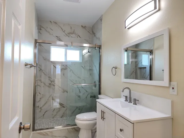 a bathroom with a sink toilet and shower