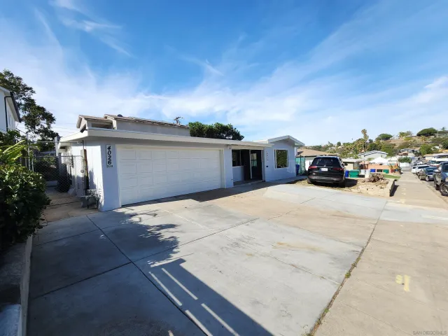 a car parked in front of white house